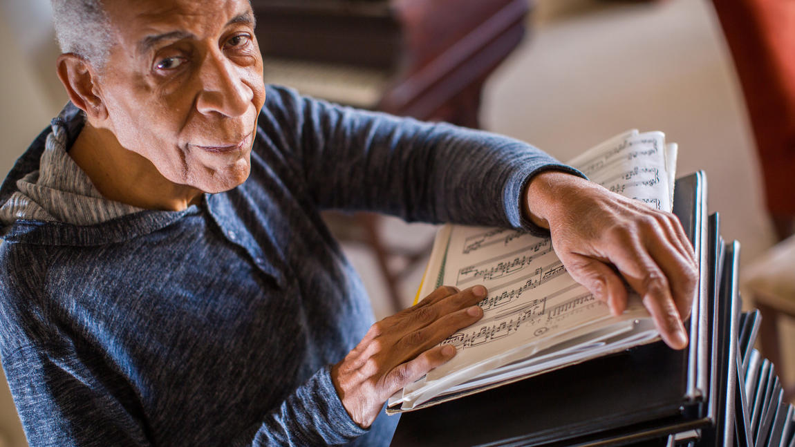 Norman holding music scores